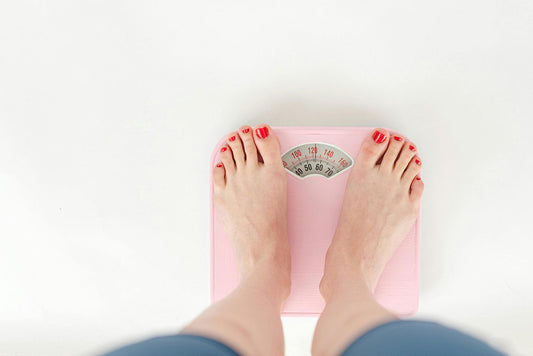 Woman using weighing scales
